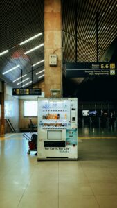 a vending machine sitting in the middle of an airport